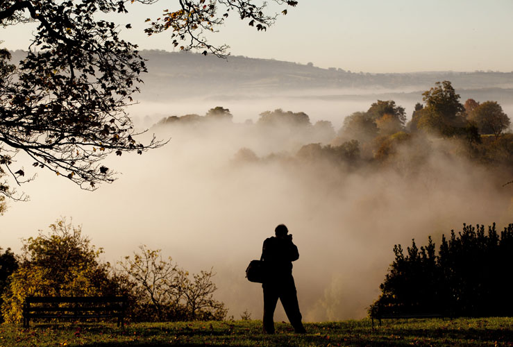 A man stops to take a picture as Bristol wakes up to heavy fog by Adam Gasson
