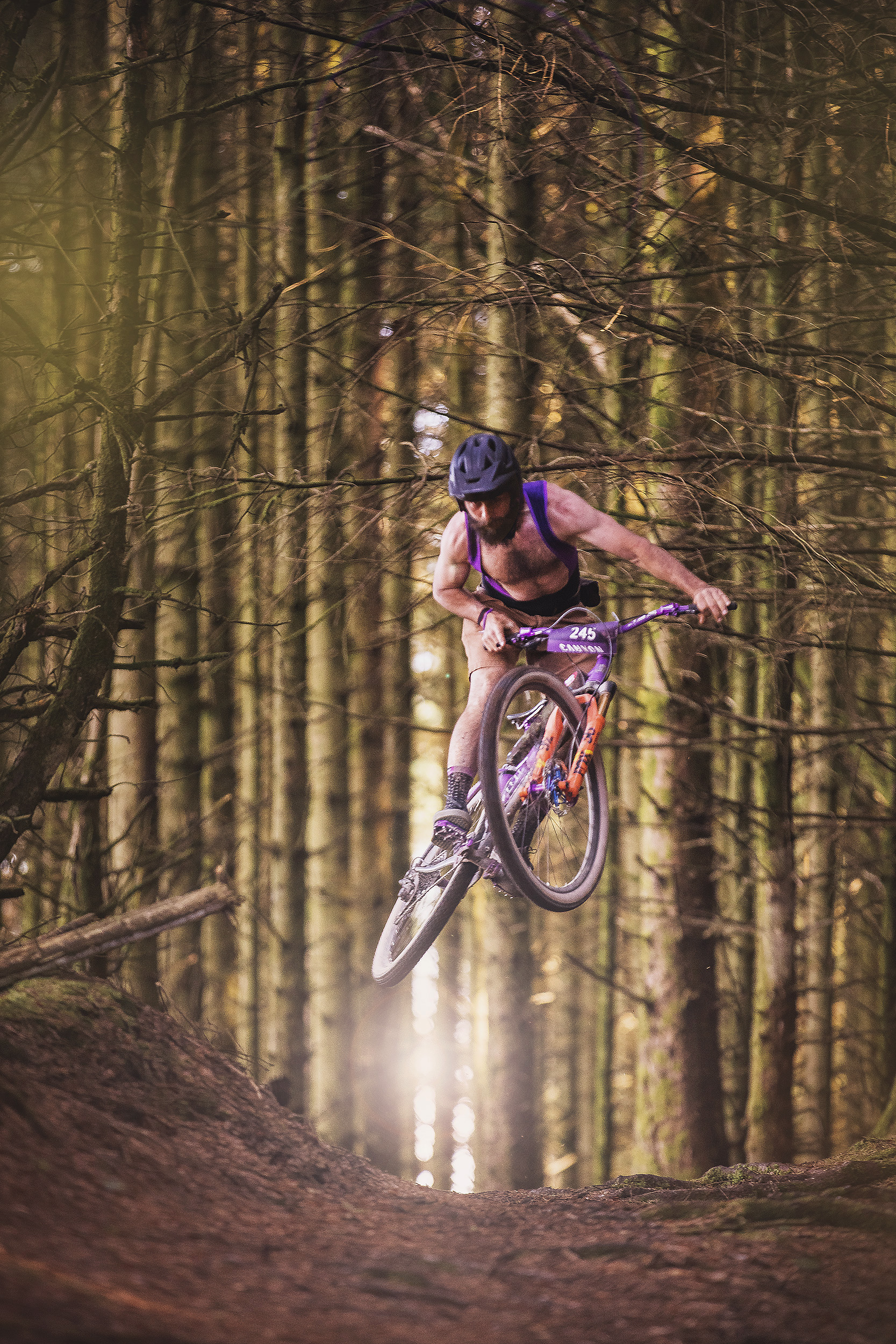 Grinduro, mountain bike rider jumping in the woods