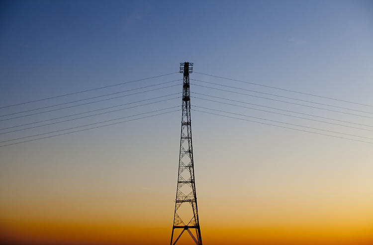 An electricity pylon crossing the River Severn at sunset by Adam Gasson