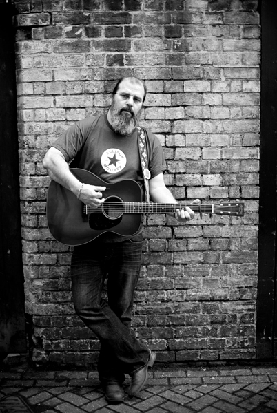 Steve Earle photographed at the Cambridge Corn Exchange for Guitarist by Adam Gasson / threesongsnoflash.net
