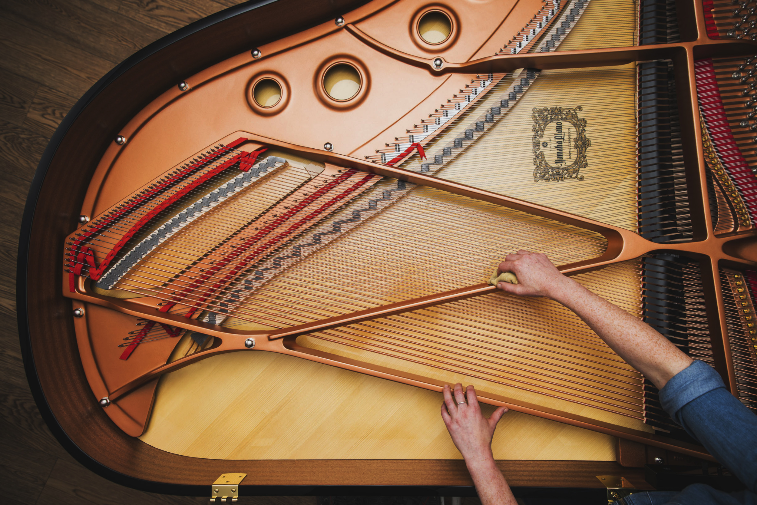 Yamaha piano technician working on an open piano