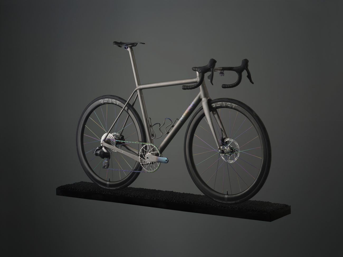 Studio photo of a Sturdy Cycles titanium 3D printed road bike floating on a small strip of tarmac