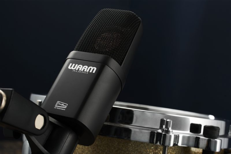 Studio photograph of a Warm Audio WA-14 Condenser microphone set up for a snare drum
